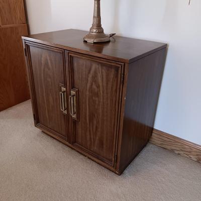 2 DOOR CABINET FILLED WITH PLACEMATS AND A LAMP WITH A DIMMER SWITCH