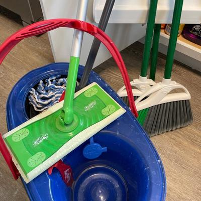 Cleaning supplies, bucket, and brooms