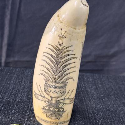 E11-Images on whale tooth replica