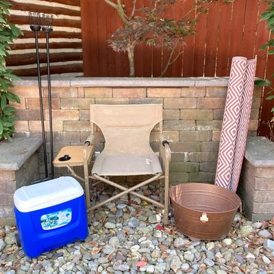 LOT 115: Outdoor Livin’ Includes and Lewis & Clark Fold & Go Directors Chair, Tiki Torches, Cooler, Copper Plated Bottle Holder...