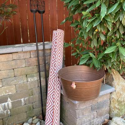 LOT 115: Outdoor Livin’ Includes and Lewis & Clark Fold & Go Directors Chair, Tiki Torches, Cooler, Copper Plated Bottle Holder...