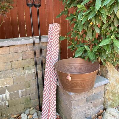 LOT 115: Outdoor Livin’ Includes and Lewis & Clark Fold & Go Directors Chair, Tiki Torches, Cooler, Copper Plated Bottle Holder...