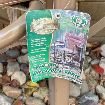LOT 115: Outdoor Livin’ Includes and Lewis & Clark Fold & Go Directors Chair, Tiki Torches, Cooler, Copper Plated Bottle Holder...