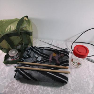 Drum sticks, antenna, lap blanket, lighter, bag, vintage can, plastic decorative jar