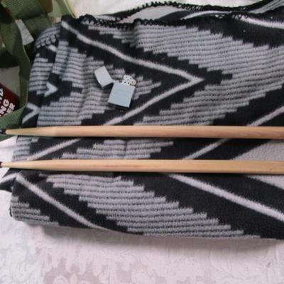 Drum sticks, antenna, lap blanket, lighter, bag, vintage can, plastic decorative jar