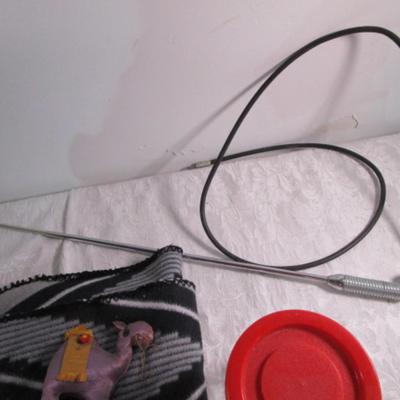 Drum sticks, antenna, lap blanket, lighter, bag, vintage can, plastic decorative jar