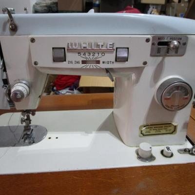 Vintage White metal sewing machine in cabinet
