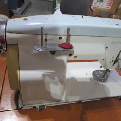 Vintage White metal sewing machine in cabinet