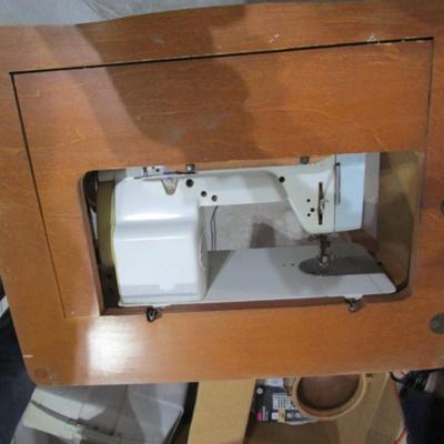 Vintage White metal sewing machine in cabinet
