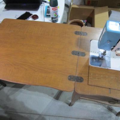 Vintage White metal sewing machine in cabinet