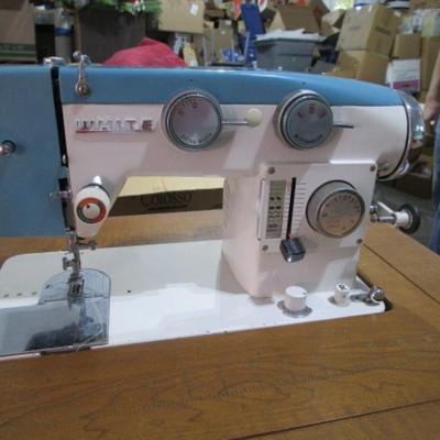 Vintage White metal sewing machine in cabinet