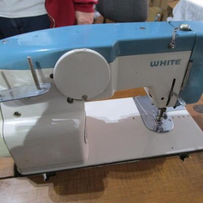Vintage White metal sewing machine in cabinet