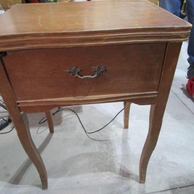 Vintage White metal sewing machine in cabinet
