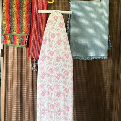 Ironing board with blue square table cloth, plus