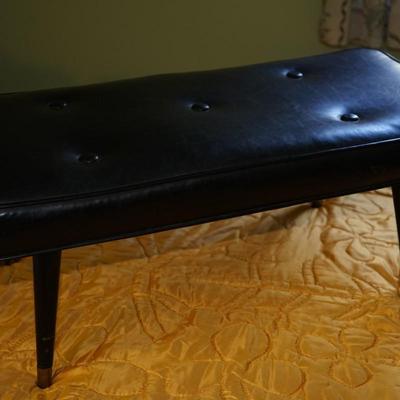 VINTAGE EARLY 70'S BLACK VINYL (BUTTON TUFT) BENCH W/ WOOD LEGS/BRASS CAPS.