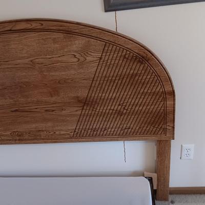 FULL SIZE BED FRAME WITH LOCKING CASTERS AND A WOODEN HEADBOARD
