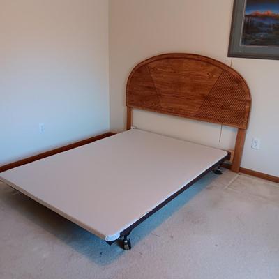 FULL SIZE BED FRAME WITH LOCKING CASTERS AND A WOODEN HEADBOARD