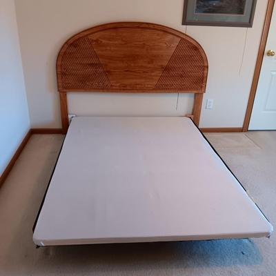 FULL SIZE BED FRAME WITH LOCKING CASTERS AND A WOODEN HEADBOARD
