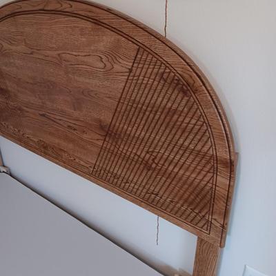 FULL SIZE BED FRAME WITH LOCKING CASTERS AND A WOODEN HEADBOARD