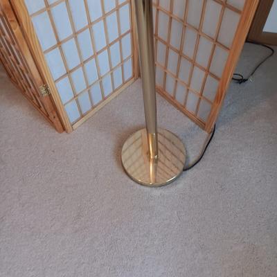 A ROOM SCREEN AND AN ADJUSTABLE BRASS COLORED FLOOR LAMP