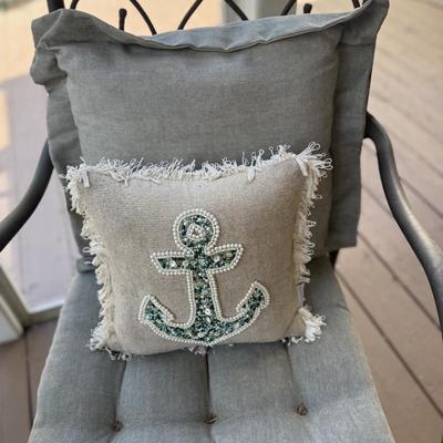 2 aluminum chairs with cushions and throw pillows