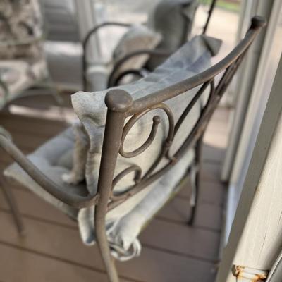 2 aluminum chairs with cushions and throw pillows