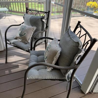 2 aluminum chairs with cushions and throw pillows