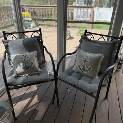 2 aluminum chairs with cushions and throw pillows