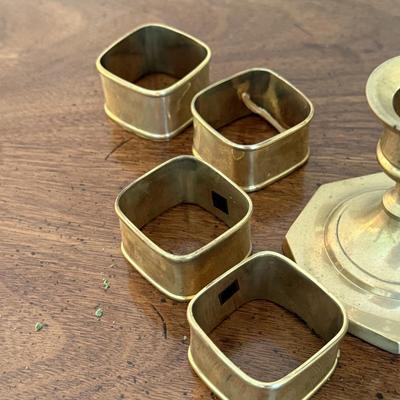 2 sets of brass candlesticks and 4 napkin rings
