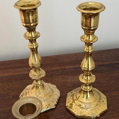 2 sets of brass candlesticks and 4 napkin rings
