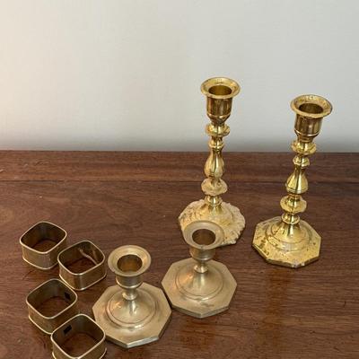 2 sets of brass candlesticks and 4 napkin rings