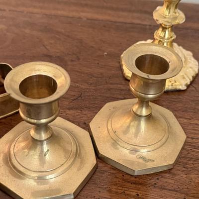 2 sets of brass candlesticks and 4 napkin rings