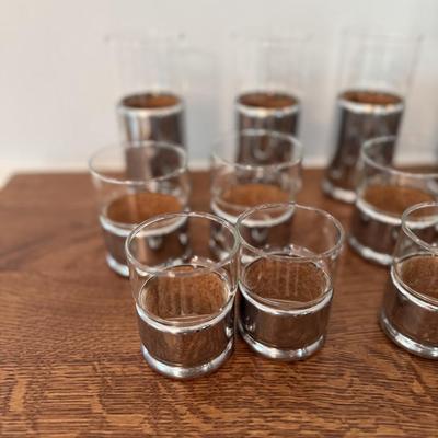 Lot of different sizes of silver and glass candle holders