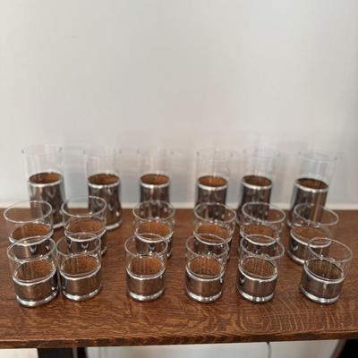 Lot of different sizes of silver and glass candle holders