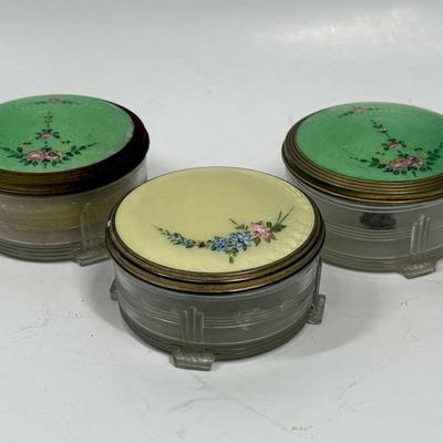 Sale Photo Thumbnail #538: These jars have been left in the state they were found in. We didn't want to disturb any of the dust. One of the jars has powder & puffs inside, on jar has original sticker, and one has a bad case of oxidation? on the lid.