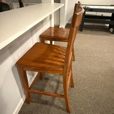 Two wood counter height stools