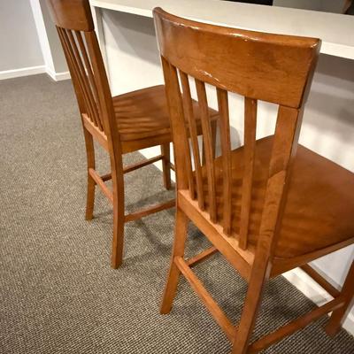 Two wood counter height stools