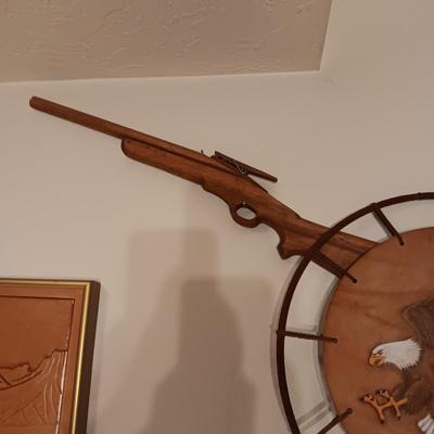 ARTWORK DONE ON LEATHER, WOODEN TOY RIFLE AND COFFEE TABLE BOOK