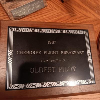 LEATHER PILOT CAP, TROPHIES AND NEWS ARTICLES REGARDING THE FATHER OF 2 SISTERS