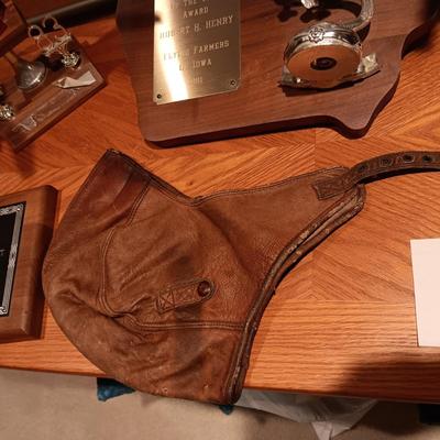 LEATHER PILOT CAP, TROPHIES AND NEWS ARTICLES REGARDING THE FATHER OF 2 SISTERS