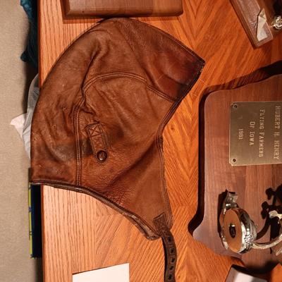LEATHER PILOT CAP, TROPHIES AND NEWS ARTICLES REGARDING THE FATHER OF 2 SISTERS