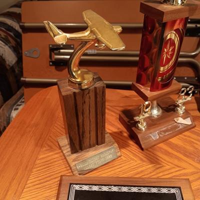 LEATHER PILOT CAP, TROPHIES AND NEWS ARTICLES REGARDING THE FATHER OF 2 SISTERS