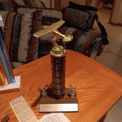 LEATHER PILOT CAP, TROPHIES AND NEWS ARTICLES REGARDING THE FATHER OF 2 SISTERS