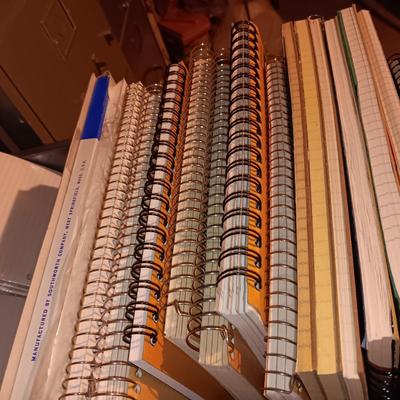 MANY SPIRAL NOTEBOOKS AND LINED PAPER