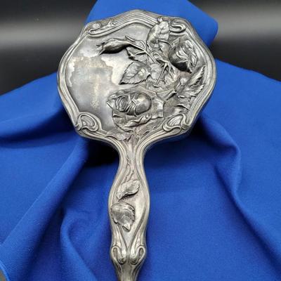 Sale Photo Thumbnail #77: Silverplate Repousse hand mirror
Rose design
Can be polished to silver sheen of left with patina of age.
Heavy tarnish
Retails at $100-150
10 inches by 5 inches