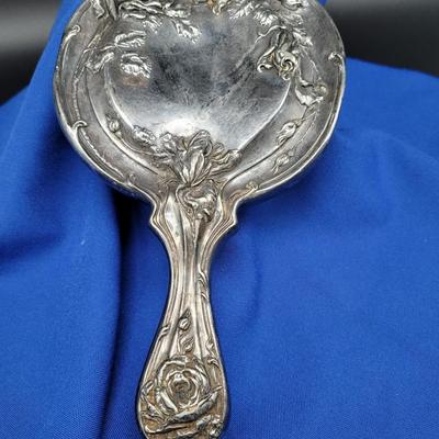 Sale Photo Thumbnail #79: Antique Repousse Mirror with roses. silverplate.
Heavily embossed, could be polished to a high sheen or
left with the patina of age.  10.5 by 6 inches
Heavy tarnish
