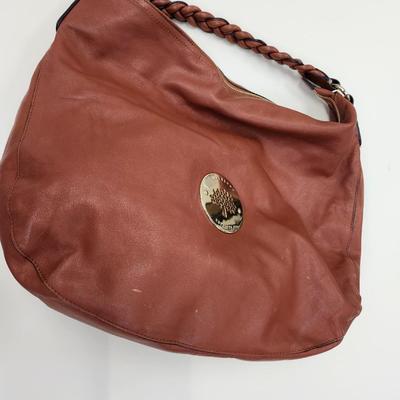 Sale Photo Thumbnail #158: Tan with braided handle, with storage bag
15 x 15 inches
2 interior zippered pockets, butter soft 
Very good condition
Retails $100-500