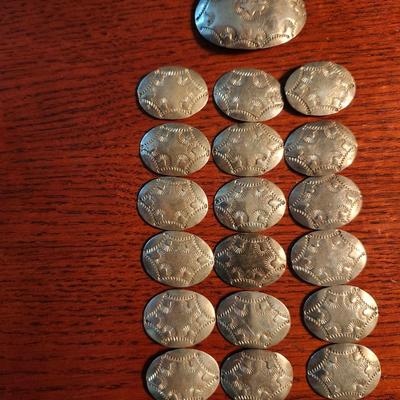 Sale Photo Thumbnail #204: Navajo, 18 matching conchos and 1 belt buckle.  All stamped, signed by Y B .  Ben Yazzie
These need to be strung on leather or ???  Beautiful condition.  
Estimate value at $500