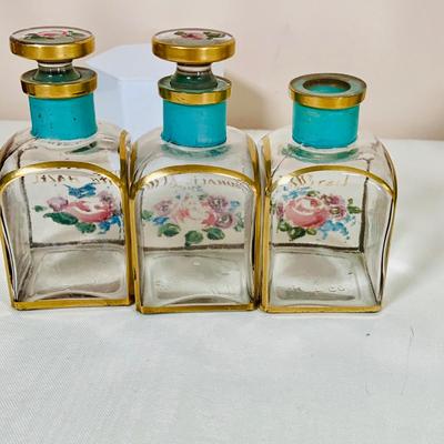 LOT 44: Vintage Vanity Necessity Including Hand Painted Glass Bottles, Metal Power Bottles, a Ceramic Jaw with Mirror Lid and More