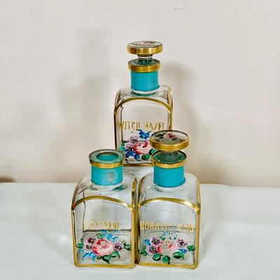 LOT 44: Vintage Vanity Necessity Including Hand Painted Glass Bottles, Metal Power Bottles, a Ceramic Jaw with Mirror Lid and More